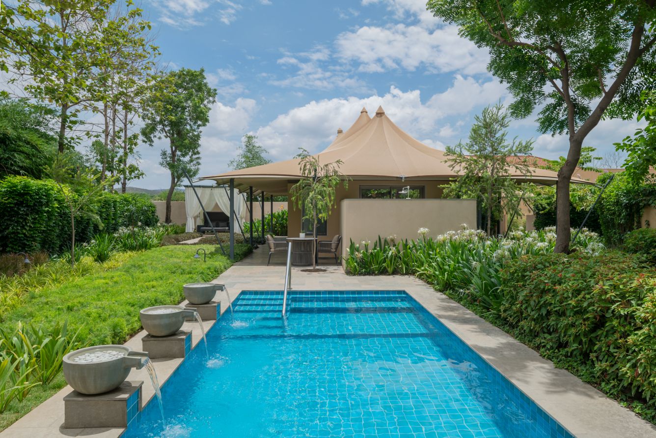 Pool and landscaped garden beside a tented suite at JW Marriott Ranthambore