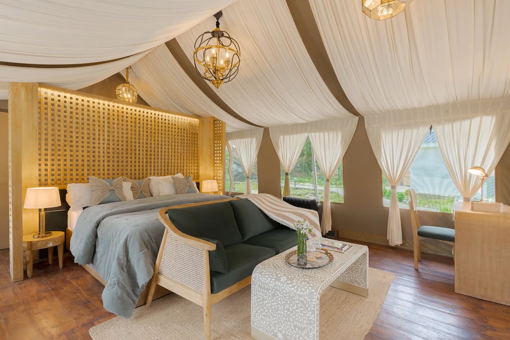Draped tent ceiling above a bedroom and lounge at Saraaya Glamps near Dharamshala