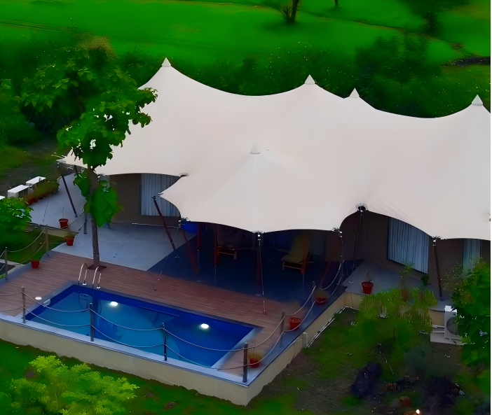 Aerial view of The Opal+ tent and pool amid green surroundings at Untamed Paws, Tipeshwar